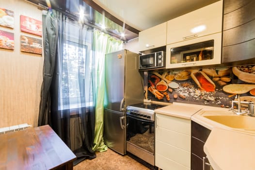 Russia, Moscow- August 01, 2019: interior room apartment. standard repair decoration in hostel. kitchen, dining area
