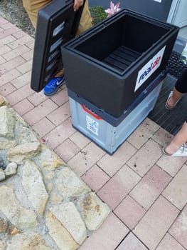 HEILIGENHAUS, NRW, GERMANY - JULY 25, 2017:.Homeservice, delivery of department store chain Real in Germany delivers crate of fresh food home.