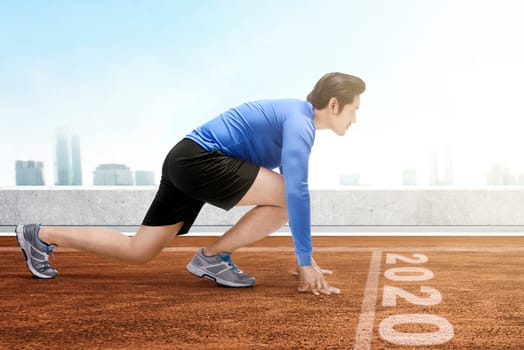 Asian runner man ready to run on the 2020 line. Happy New Year 2020
