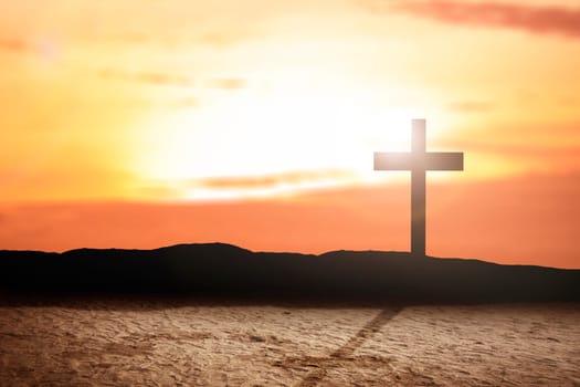 Christian Cross on the field with a sunset sky background