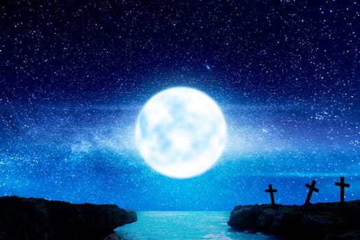 Christian Cross on the beach with moonlight background