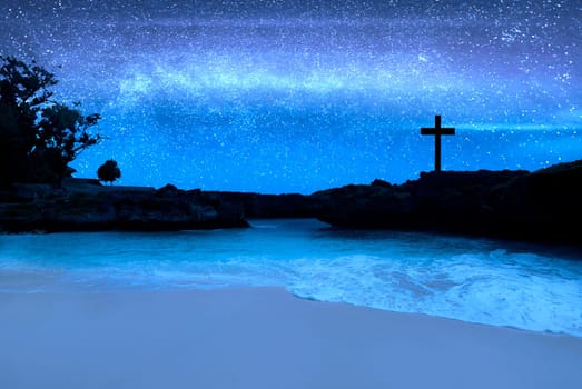 Christian Cross on the beach with a night scene background