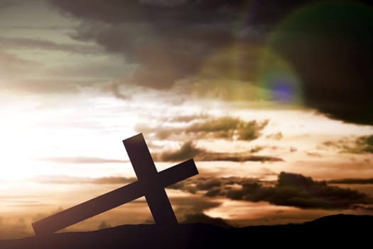 Christian Cross on the field with a dark sky background