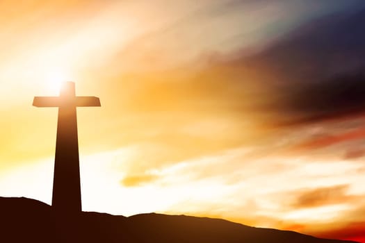 Christian Cross on the field with a sunset sky background