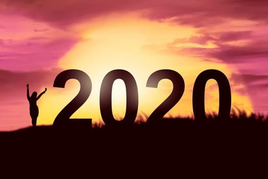Silhouette of businesswoman celebrating the new year. Happy New Year 2020