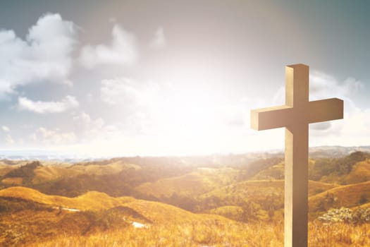 Christian cross on the top of the hills with sunlight and blue sky background
