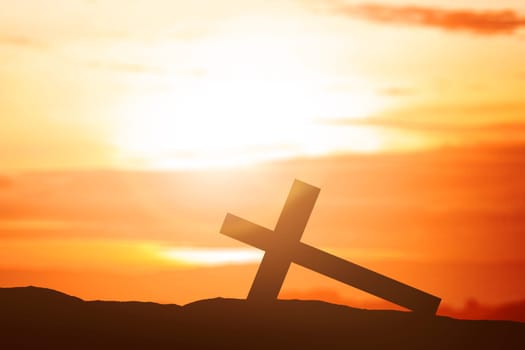 Christian Cross on the field with a sunset sky background