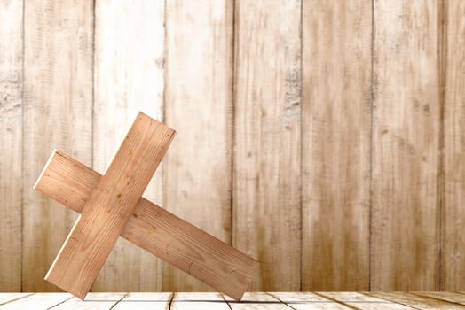Christian Cross on the table with wooden wall background