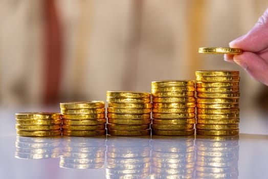 Save money and account banking for finance business concept, Hand with coin money on blurred background