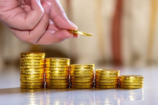 Save money and account banking for finance business concept, Hand with coin money on blurred background