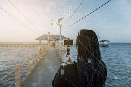 Social network and photography concept, Women with smart phone mobile in seascape nature background