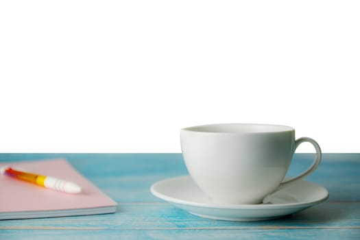 A cup of coffee with notebook on wooden isolated on white background