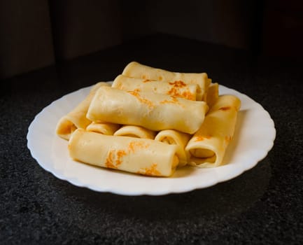 Rolled and filled pancakes on a plate