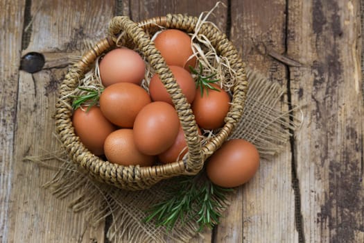 eggs in a basket on wooden background