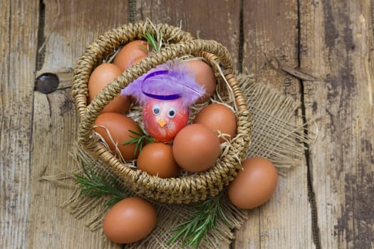 eggs in a basket on wooden background