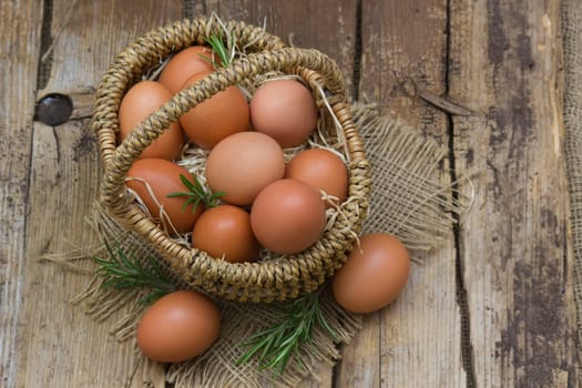 eggs in a basket on wooden background
