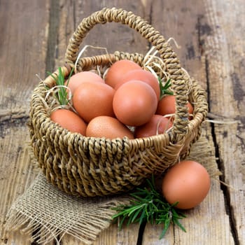 eggs in a basket on wooden background