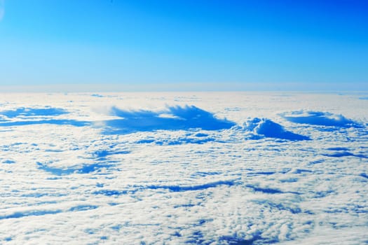 Blue sky and clouds. Plane view above the earth, can be used for background