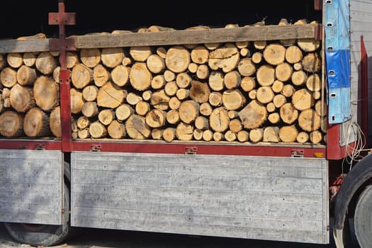 Wood logs firewood stacked on truck
