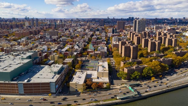 Aerial view over the far north on Manhattan Island in and around Harlem NY