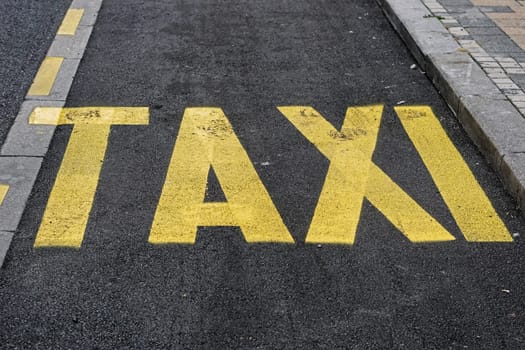 Yellow taxi sign paint at new black tarmac