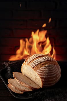 Traditional house bread on the table in front of a brick oven