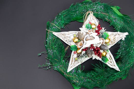 Handmade star decorated with cones and cranberries with christmas deer