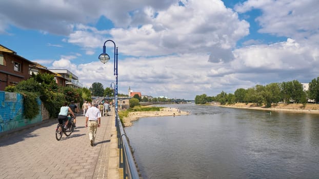 Walkers on a promenade on the banks of the River Elbe in Magdeburg