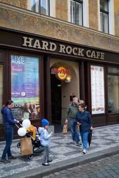 Tourists in front of the popular Hard Rock Cafe in the historic house "U Rotta"" in the Old Town of Prague"