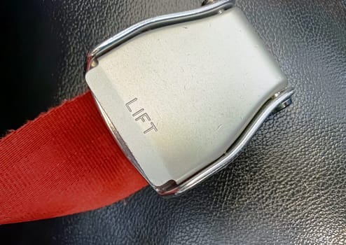 Close up of an aircraft safety belt buckle. Plane safety.