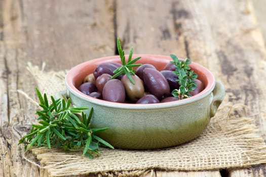 red kalamata olives and herbs in a bowl