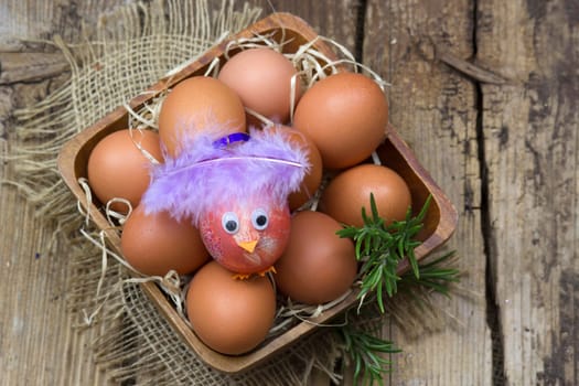 eggs in a bowl on wooden background