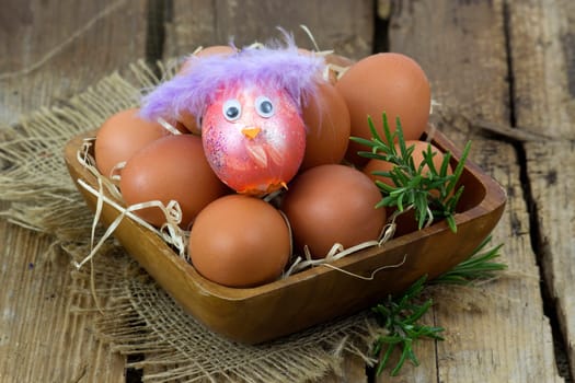 eggs in a bowl on wooden background