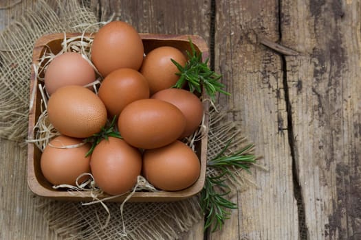 eggs in a bowl on wooden background