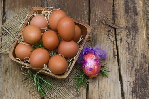 eggs in a bowl on wooden background