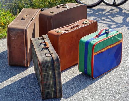 Many retro style suitcases luggage at flea market