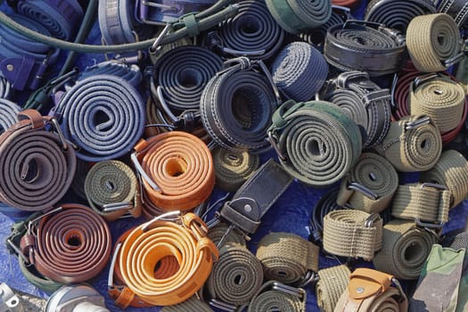 Various military style belts in coils for sale