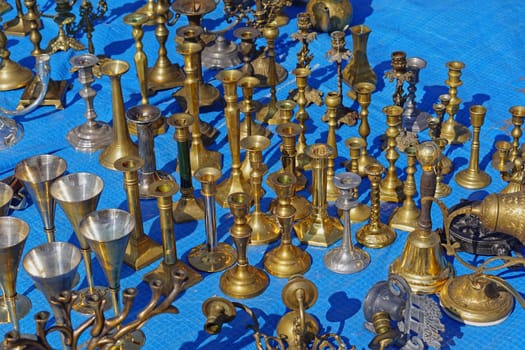 Antique brass and bronze candleholders for sale at flea market