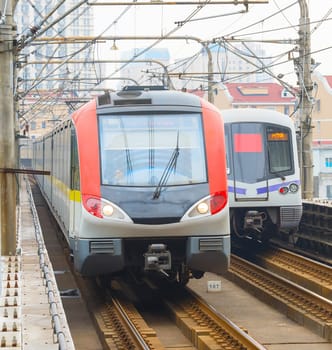 Shanghai metro train leaving an underground station while another train is arriving. Shanghai , China
