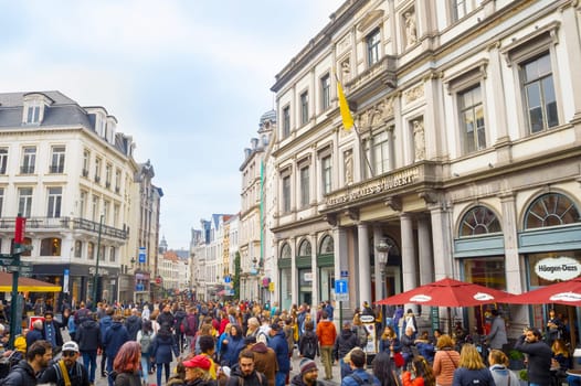 BRUSSELS, BELGIUM - OCTOBER 5, 2019: Crowd of people on Old Town street in front of the Saint-Hubert Royal Galleries - shopping arcades in Brussels, Belgium