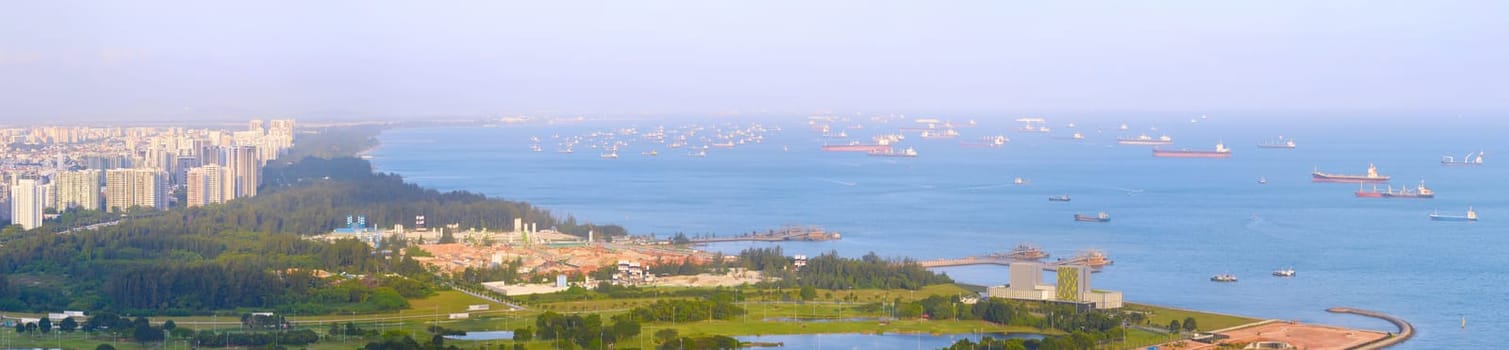 Panorama of Singapore harbor with many cargo ships at sunset. Singapore