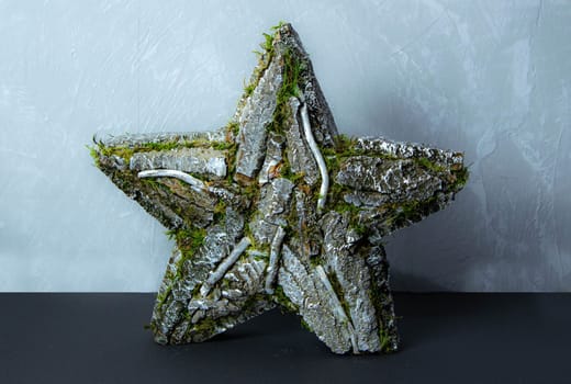Handmade star decorated with cones and cranberries with christmas deer