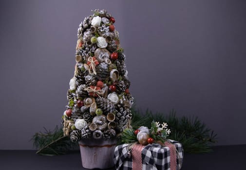 Handmade star decorated with cones and cranberries with christmas deer