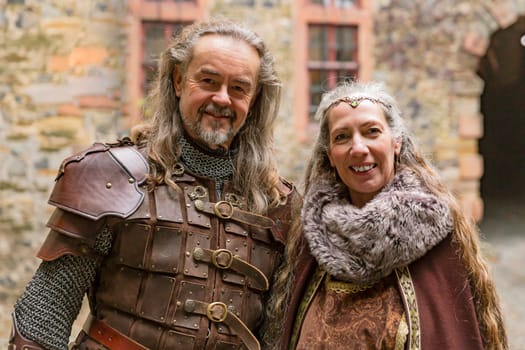Couple posing robed in beautiful medieval clothing