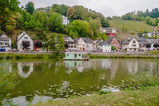 Idyllic Lahn River with wooden House Boat in Germany