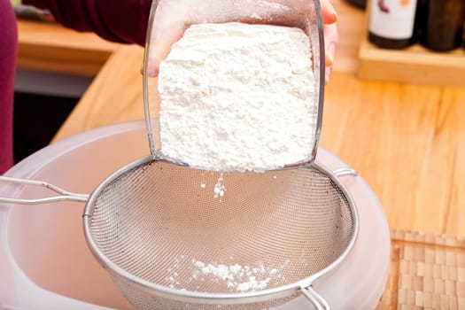 Put flour of glass bowl through a flour sieve to make a cookie dough