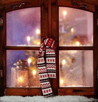 Close up Christmas Scarf Hanging on Vintage Wooden Window Pane with Small Amount of Snow.