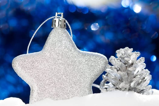 Silver christmas decoration with ball and cone on blue background