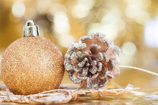 Golden Christmas background with christmas ball and cone