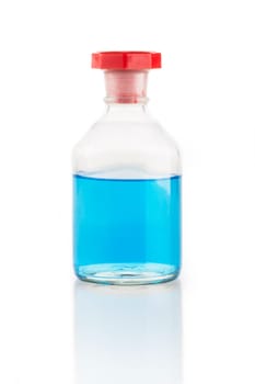 Clear glass bottle with blue liquid and red stopper.